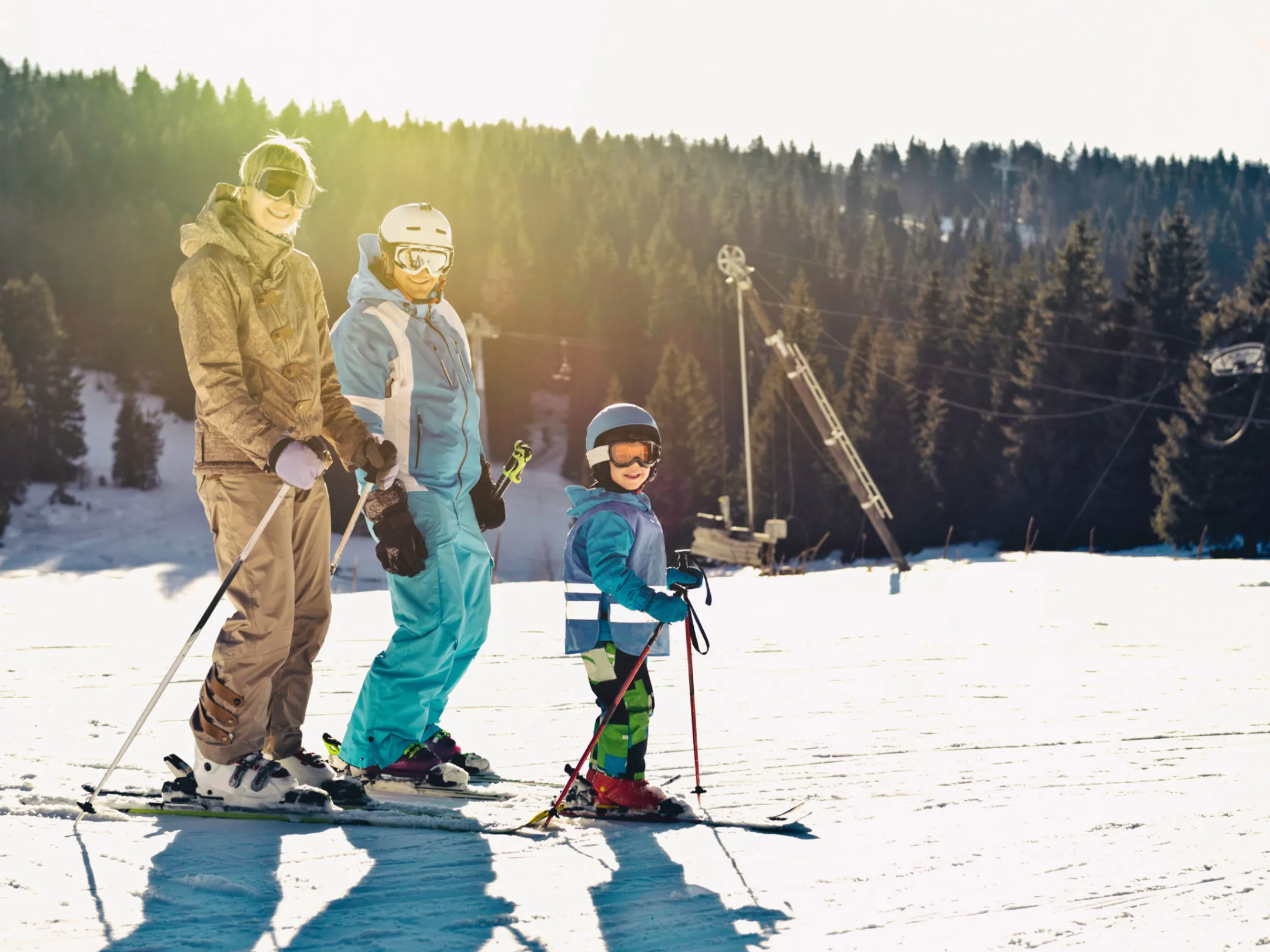 a group of people riding skis on top of a snow covered slope