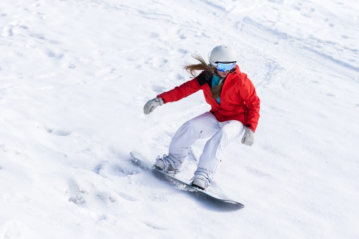 a man riding skis down a snow covered slope