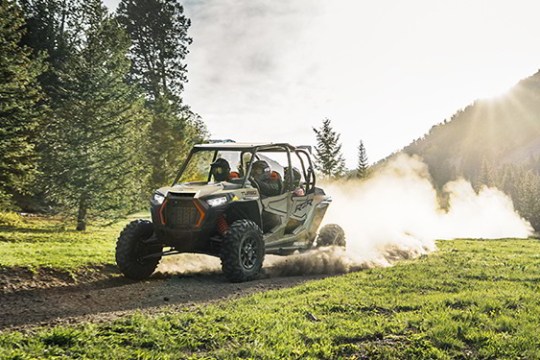 a truck driving down a dirt road